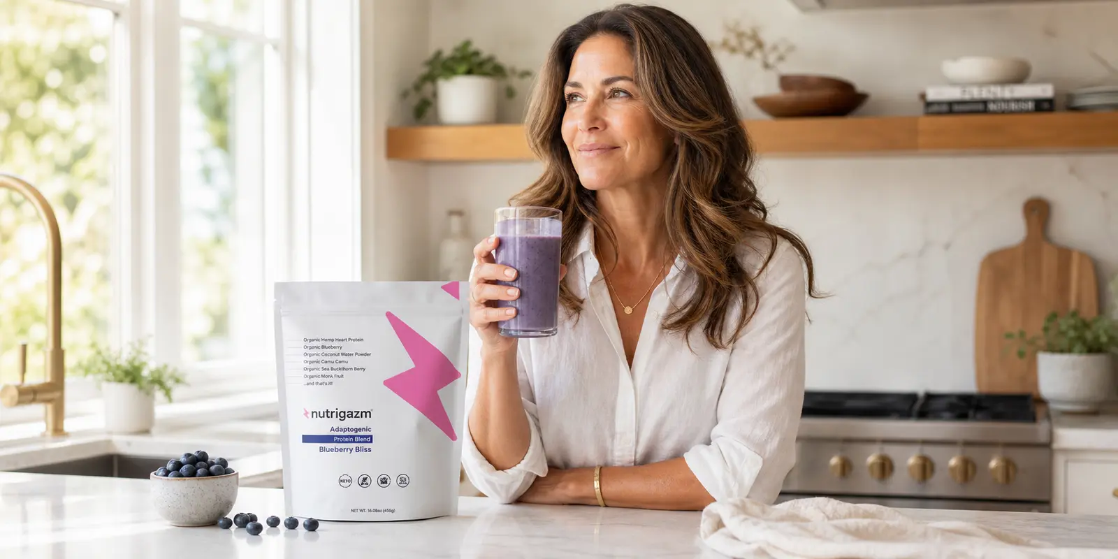 Woman holding a blueberry smoothie beside a Nutrigazm hemp heart protein blend